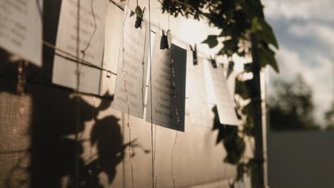 Scenic-shot-of-quotes-hanging-on-clothing-pins-in-the-sunlight-outdoors-at-wedding-event