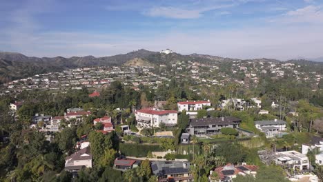 Drone-Flyover-Hollywood-Hills-Neighborhood-Towards-Griffith-Observatory,-4K-Los-Angeles