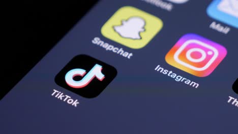 Swipe-on-smartphone-showing-Snapchat,-Instagram-and-TikTok-App