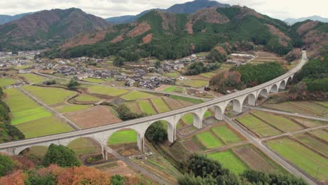 Geometrical-Bridge-around-Japanese-Countryside-Valley-Village-Green-Natural-Aerial-Drone-Landscape,-Takeda-Castle,-Asago-Hyogo-Japan