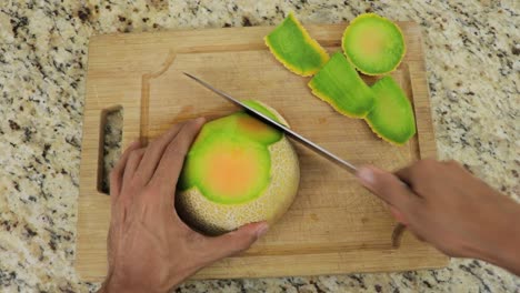 Removing-peel-from-melon-using-sharp-knife