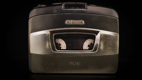 Aiwa-Walkman-With-Rolling-Cassette-Tape,-Close-Up
