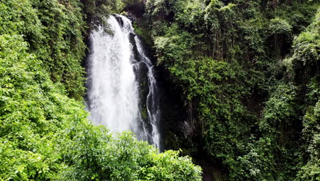 Lush-greenery-surrounds-a-cascading-waterfall-in-Banos,-Ecuador,-nature's-serenity-captured