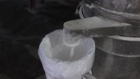 POV-SHOT-The-sugar-runs-out-of-the-machine-and-falls-inside-the-bucket