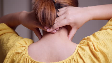 Close-up-shot-of-a-woman-massaging-her-nape-using-her-hands-and-fingers-to-relieve-the-tension-and-stress-that-she-is-feeling