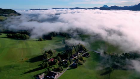 The-image-is-an-aerial-view-of-a-valley-filled-with-white,-fluffy-clouds