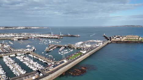 St-Peter-Port-Guernsey-aerial-shot-out-towards-Castle-Cornet-and-across-to-Herm-showing-commercial-port-ferry-terminal-and-marinas