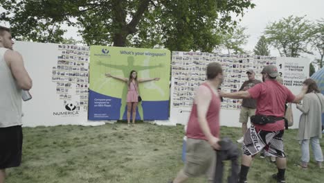 Hoopfest-2018---girl-measuring-herself-against-the-size-of-a-basketball-player