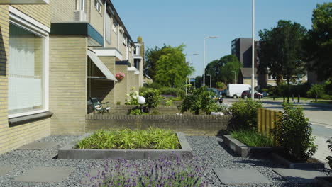 Female-health-practitioner-walks-towards-patient-house-on-sunny-day,-side-view