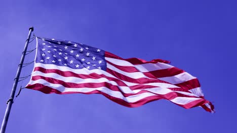 Sky-around-USA-American-flag-flying-in-wind-on-pole