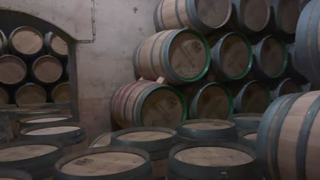 Aged-wine-barrels-stacked-in-dim-cellar