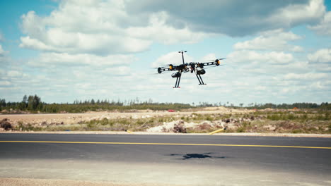 Professional-gasoline-powered-large-drone-taking-off-from-small-airfield-taxiway-towards-blue-skies