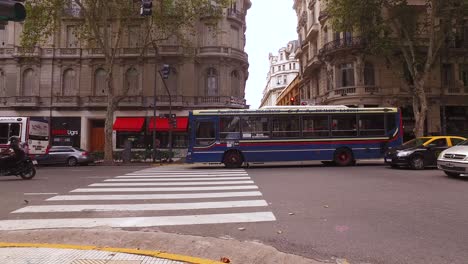 Buenos-Aires,-Argentina,-Downtown-Traffic-on-Avenida-de-Mayo-Including-Bus-Lines-Public-Transportation