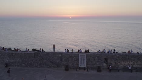 Aerial-view-of-Cefalu-medieval-city-during-summer-at-sunset,-Sicily,-Italy