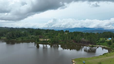 Aerial-shot-of-serene-Pea-Aeknetonang-Lake,-Samosir-Island-within-Lake-Toba,-overcast-sky