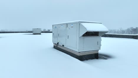 Industrial-rooftop-HVAC-unit-on-a-snow-covered-flat-roof