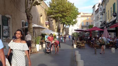 Women-with-stroller-and-others-walk-by-restaurants-in-Antibes-Old-Town