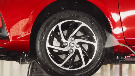 Auto-Care:-Jet-Spray-Cleaning-of-Red-Car-Wheel-and-Front-Fender-for-a-Gleaming-Finish