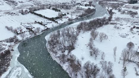 Drone-shot-of-snow-falling-on-the-Yakima-River-and-surrounding-farmland-in-Washington