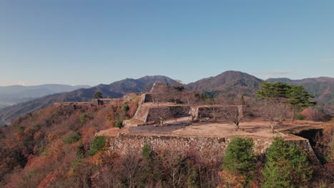 Panoramic-Drone-Fly-Above-Japanese-Takeda-Ancient-Castle-Ruins,-Natural-Travel-Landscape-with-Fortress