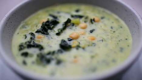 Creamy-kale-soup-bowl-spinning-in-close-up