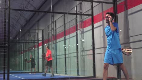 Pro-padel-player-hit-padel-tennis-ball-in-slow-motion-at-idoor-padel-court