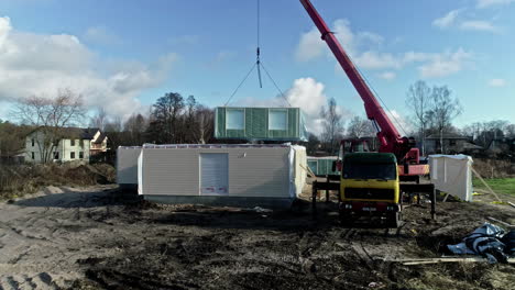 Assembly-Of-Modular-Prefab-House-With-Mobile-Crane-In-Daytime