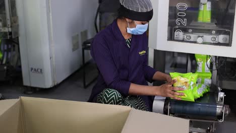 pov-shot-slow-motion-seen-man-picking-up-chips-packet-and-arranging-in-box