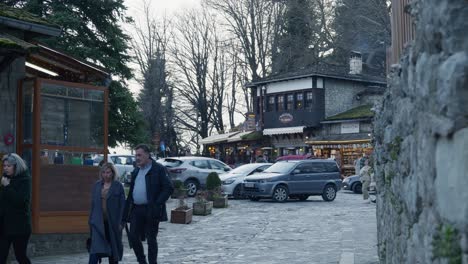 People-walking-traditional-old-stone-cobblestone-street-alley-Metsovo-greece