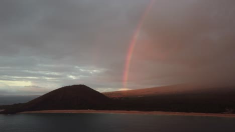 Epic-aerial-shot-of-a-rainbow-over-beautiful-South-Maui-beach,-Maui-County,-Hawaii
