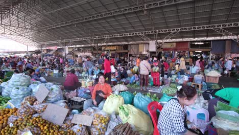 A-vast,-bustling-open-air-public-market-where-individuals-showcase-their-wares,-with-many-seated-on-the-ground