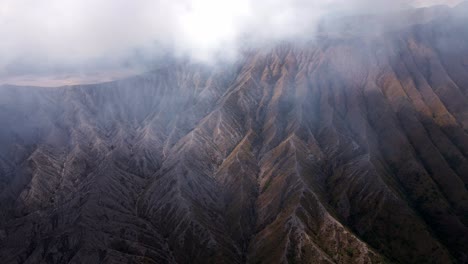 the-shivering-majesty-of-Mount-Bromo's-active-volcano,-a-dangerous-and-myterious-mountain-in-East-Java,-aerial-4k-footage