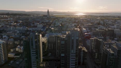 Reykjavik-skyline-with-high-rise-buildings-and-Hallgrimskirkja-church,-aerial