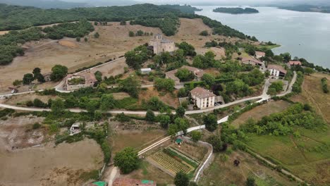 Nanclares-de-gamboa-village-in-basque-country,-spain,-with-lake-and-castle,-aerial-view