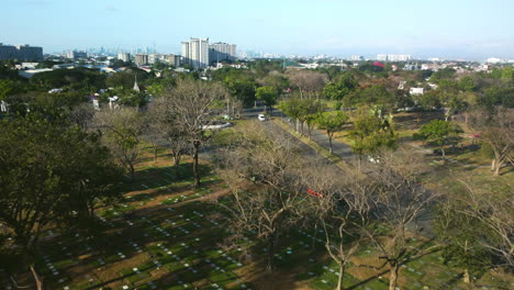 Aerial-view-over-the-Manila-memorial-park,-sunny-day-in-the-Philippines