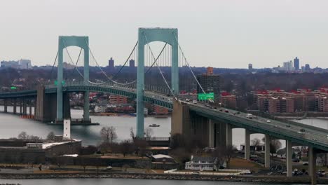 An-aerial-view-of-the-Throgs-Neck-Bridge-from-over-the-Long-Island-Sound,-NY-on-a-cloudy-day