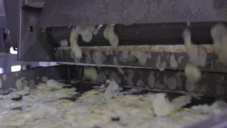 pov-shot-close-up-seen-Chips-are-fried-and-poured-into-the-packaging-process