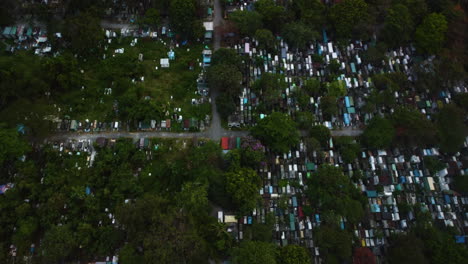 Aerial-view-overlooking-the-Manila-south-cemetery,-in-cloudy-Makati,-Philippines