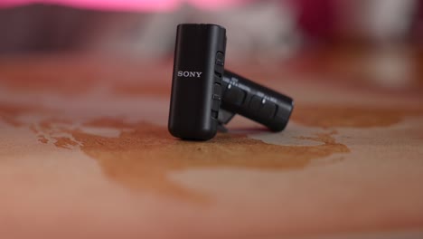 Sony-Wireless-Microphone-And-Receiver-On-Table-With-Bokeh-Background