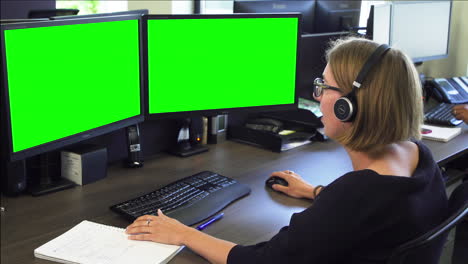 Double-green-screen,-woman-putting-on-headset-to-start-conversation-with-client