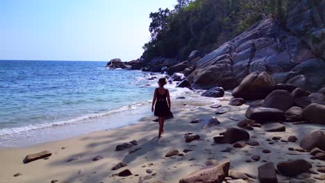 Woman-explores-lonely-dream-beach-on-island