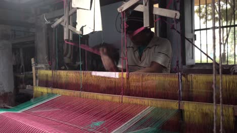 A-weaver-weaves-cloth-in-an-ancient-way