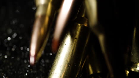 300-AAC-Blackout-and-6mm-ARC-bullets-falling-on-gunpowder-pile,-macro-detail