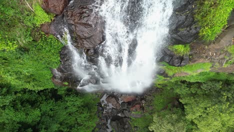 Water-from-a-rainforest-stream-rushes-over-a-sheer-rock-cliff-creating-a-spectacular-waterfall