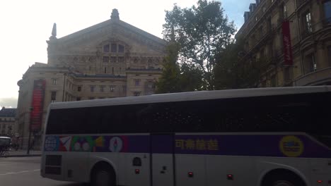 Slomo-shot-of-traffic-in-front-of-Palais-Garnier-in-Paris,-France