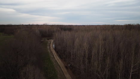 Loosahatchie-park-in-tennessee-with-bare-trees-and-a-curving-path,-cloudy-day,-aerial-view