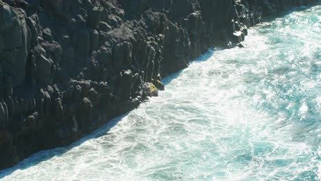 Foamy-Atlantic-ocean-waves-hitting-rocky-coast-of-Tenerife-island,-slow-motion