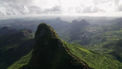 Le-pouce-mountain-near-port-louis,-lush-greenery-under-a-cloudy-sky,-aerial-view