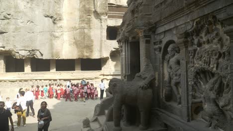 Surviving-rock-cut-sculptures-and-artwork-at-Ellora-Caves,-Tourists-sightseeing-Ellora-monuments