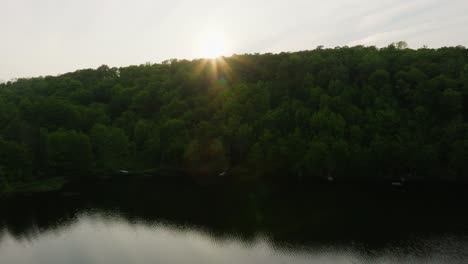 Sunset-Over-Calm-Lake-With-Reflection-In-Quebec,-Canada---Drone-Shot